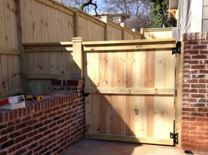 Custom wood gate with brick pillars — Concord NC